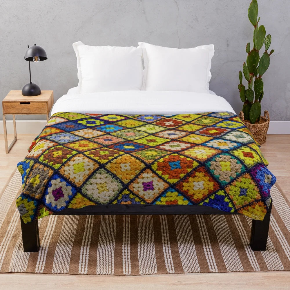 Handmade crochet granny square pattern blanket in various colors