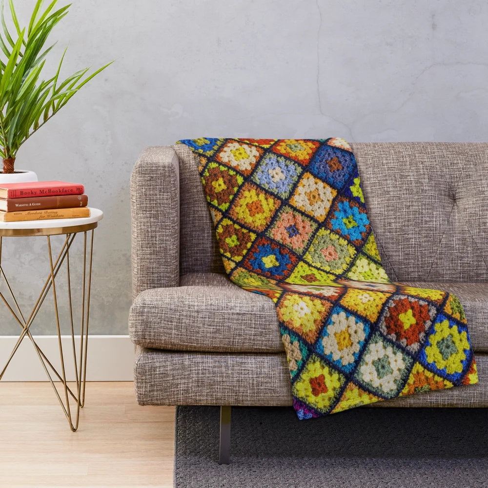Handmade crochet granny square pattern blanket in various colors