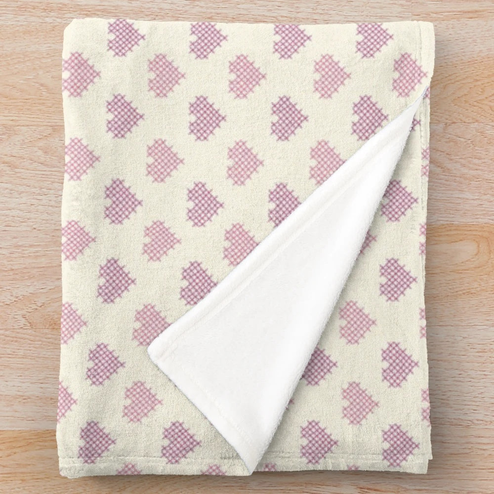 Soft and plush blanket with cross-stitched hearts design
