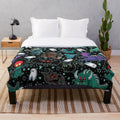 Cozy Cryptid Plush Blanket featuring various cryptid illustrations