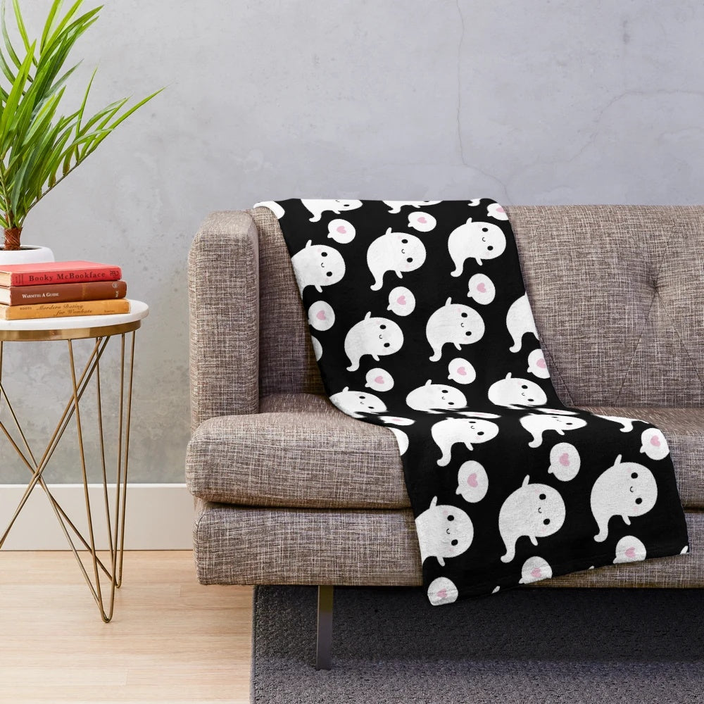 Soft and plush blanket featuring a cute, smiling ghost design in a cozy autumn theme