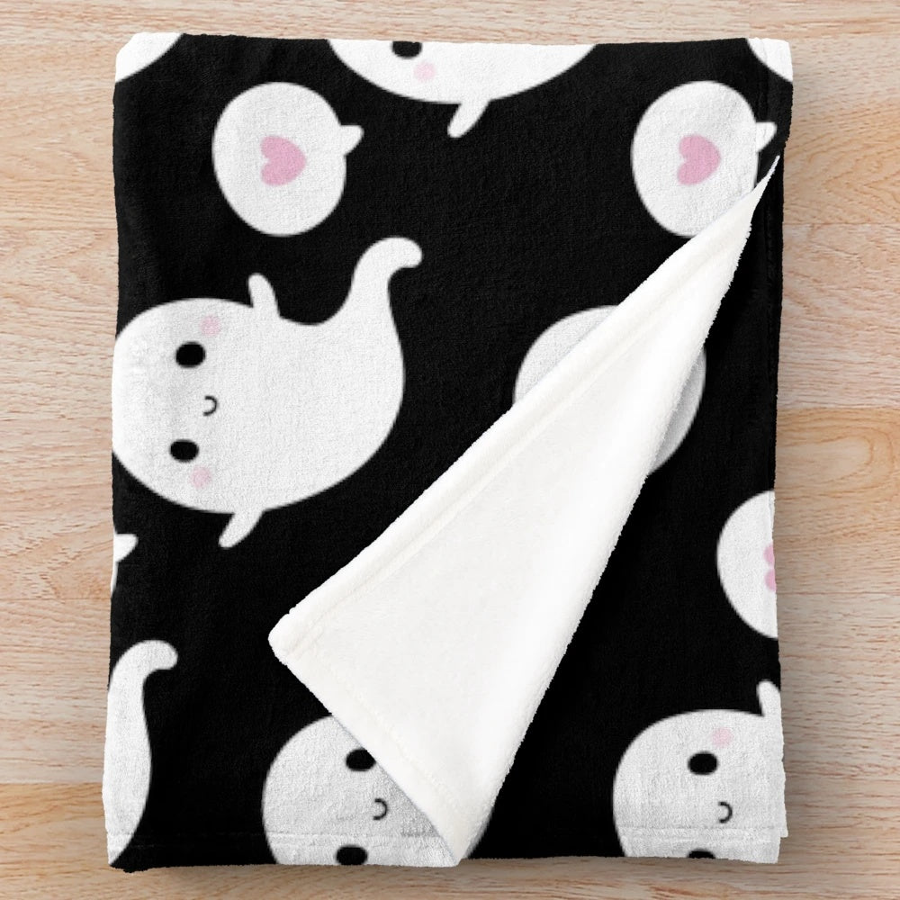 Soft and plush blanket featuring a cute, smiling ghost design in a cozy autumn theme