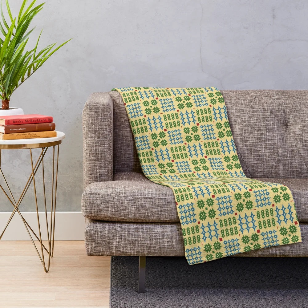 Plush blanket with traditional Welsh Penmynydd pattern in green and blue colors