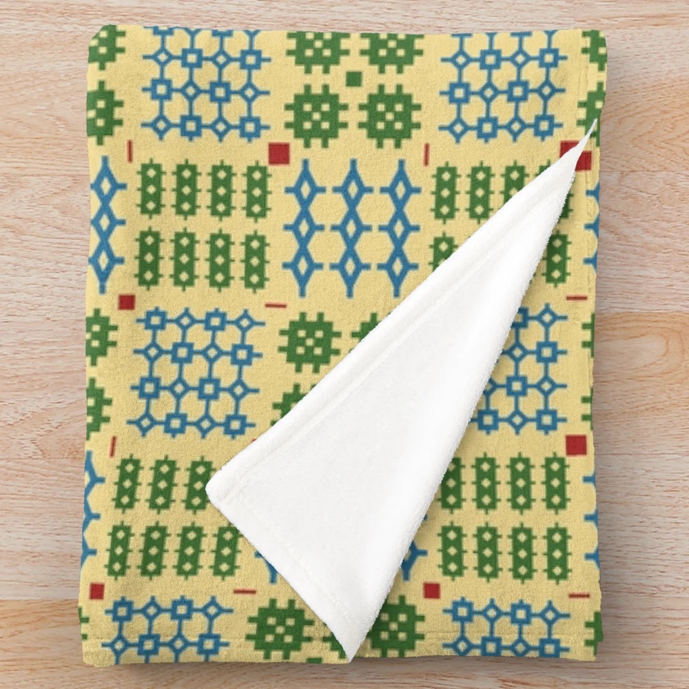 Plush blanket with traditional Welsh Penmynydd pattern in green and blue colors