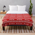 Dachshund dog wearing a Christmas sweater pattern on a plush blanket