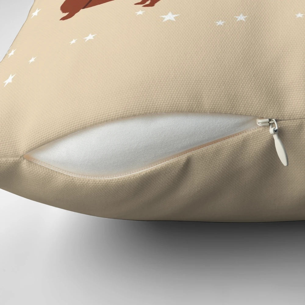 Dachshund Through The Snow Pillow featuring a dachshund dog wearing a Santa hat surrounded by Christmas decorations.