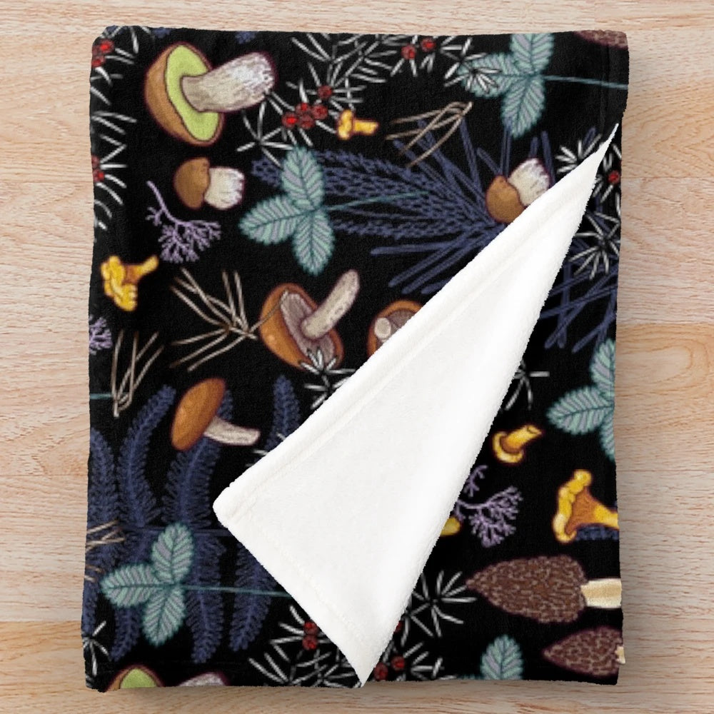 Plush blanket with a dark forest mushroom pattern