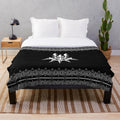 Dark plush blanket with machine-inspired, futuristic design