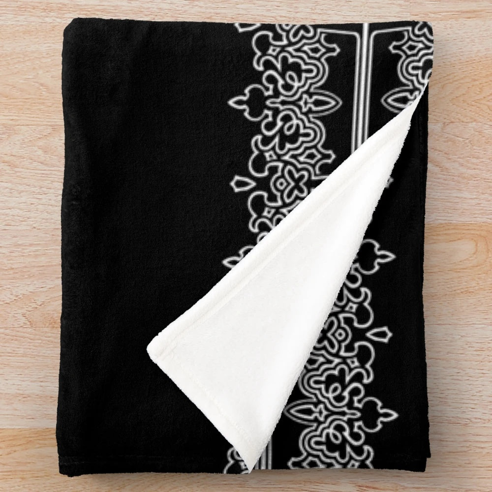 Dark plush blanket with machine-inspired, futuristic design