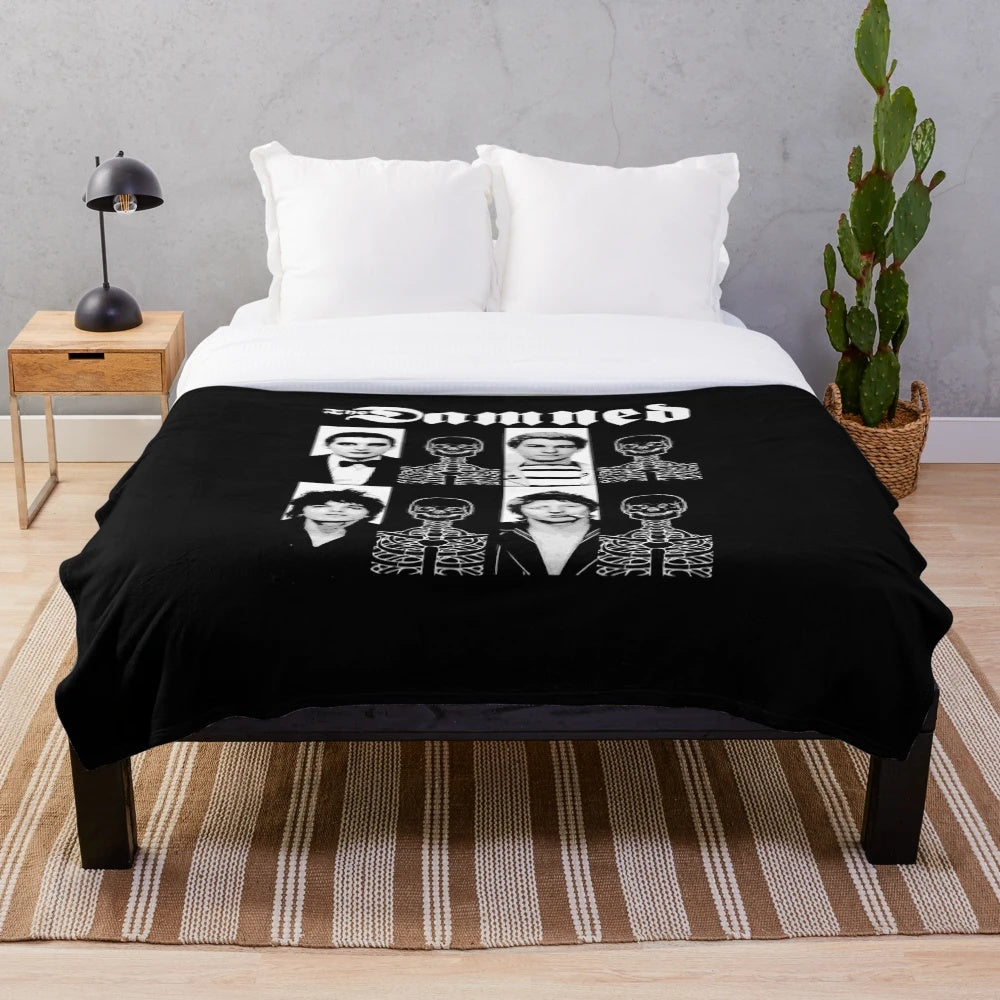 A plush black blanket with The Damned band logo