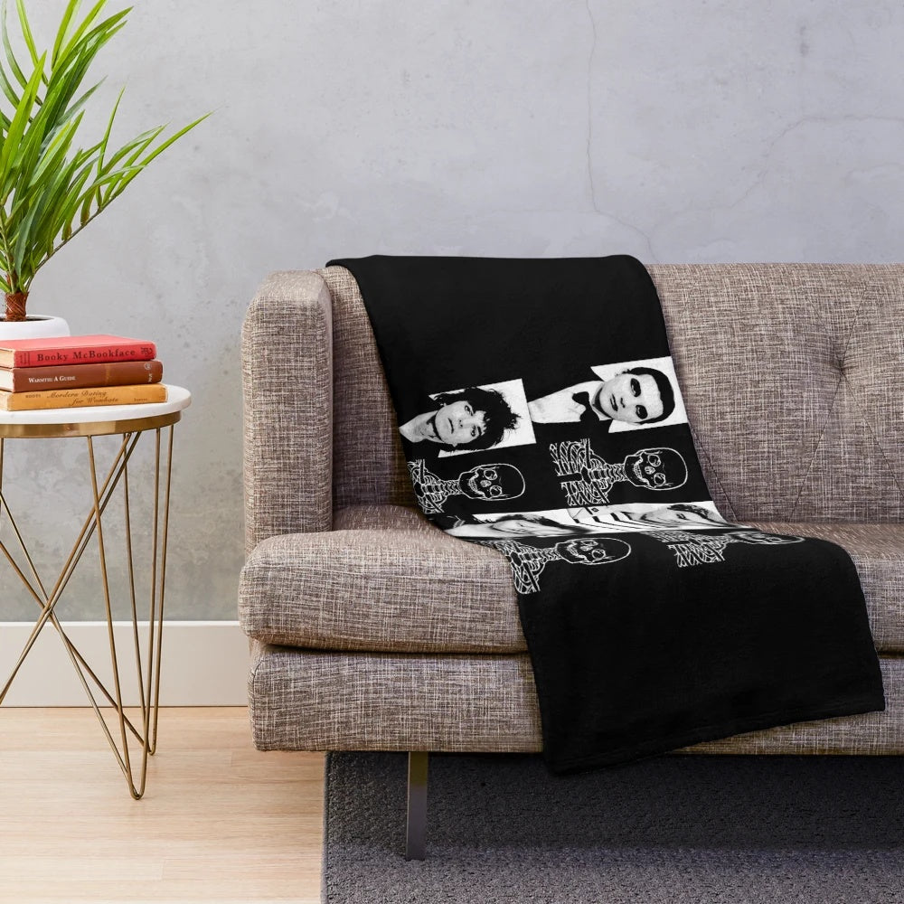 A plush black blanket with The Damned band logo