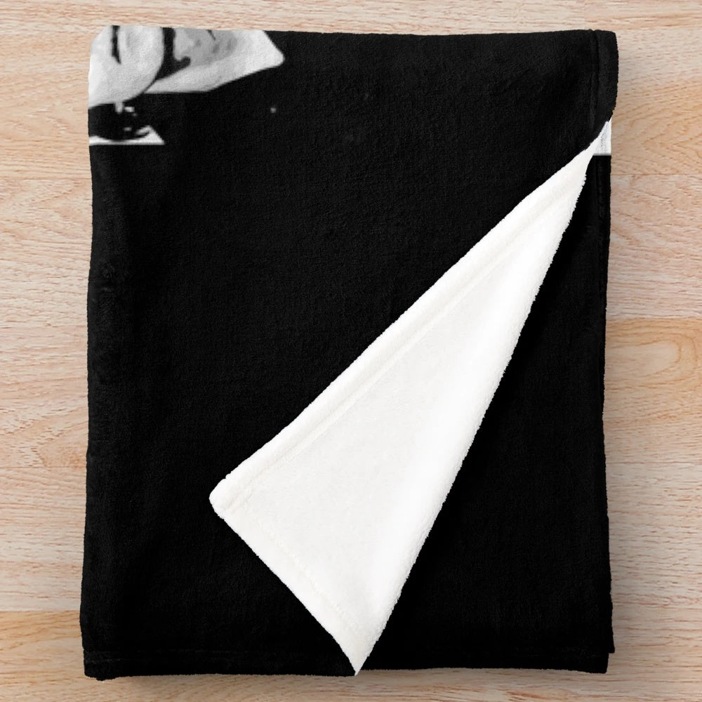 A plush black blanket with The Damned band logo