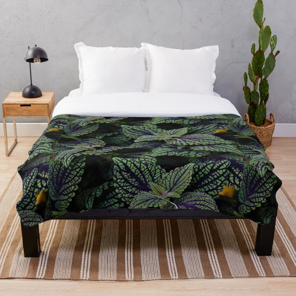 Deep green plush blanket with nature-inspired floral design