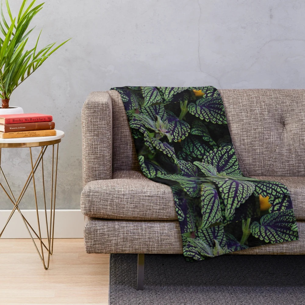 Deep green plush blanket with nature-inspired floral design
