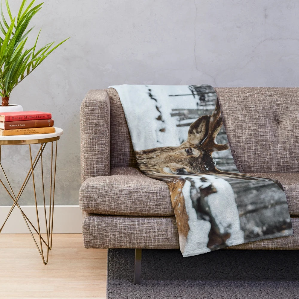 Deer in a snowy winter landscape on a plush, cozy blanket