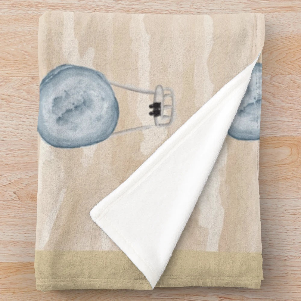 Plush blanket with a seamless pattern of air balloons floating over a desert landscape