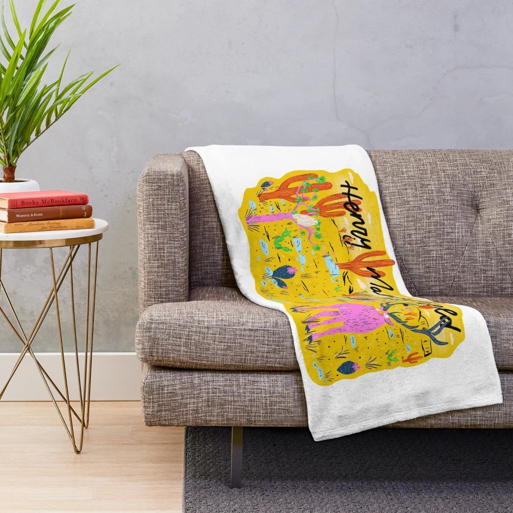Plush blanket featuring an elk in a desert cactus scene