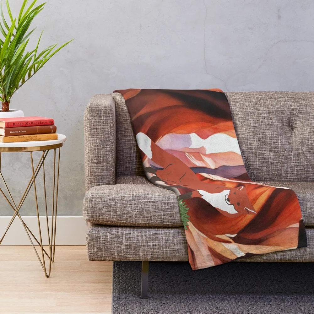 Plush blanket featuring a desert fox illustration in brown and red tones