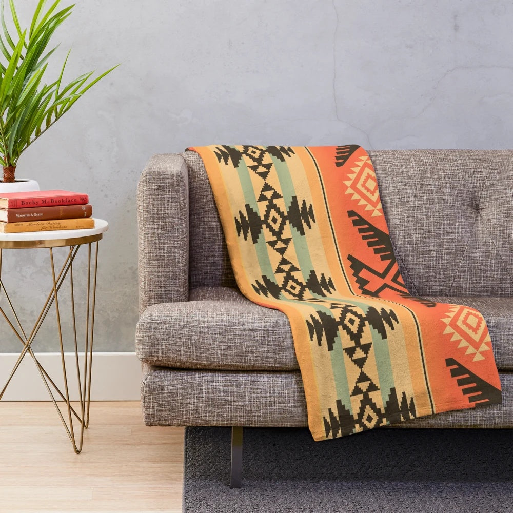 A plush and cozy blanket featuring a beautiful native american-inspired tribal pattern design.