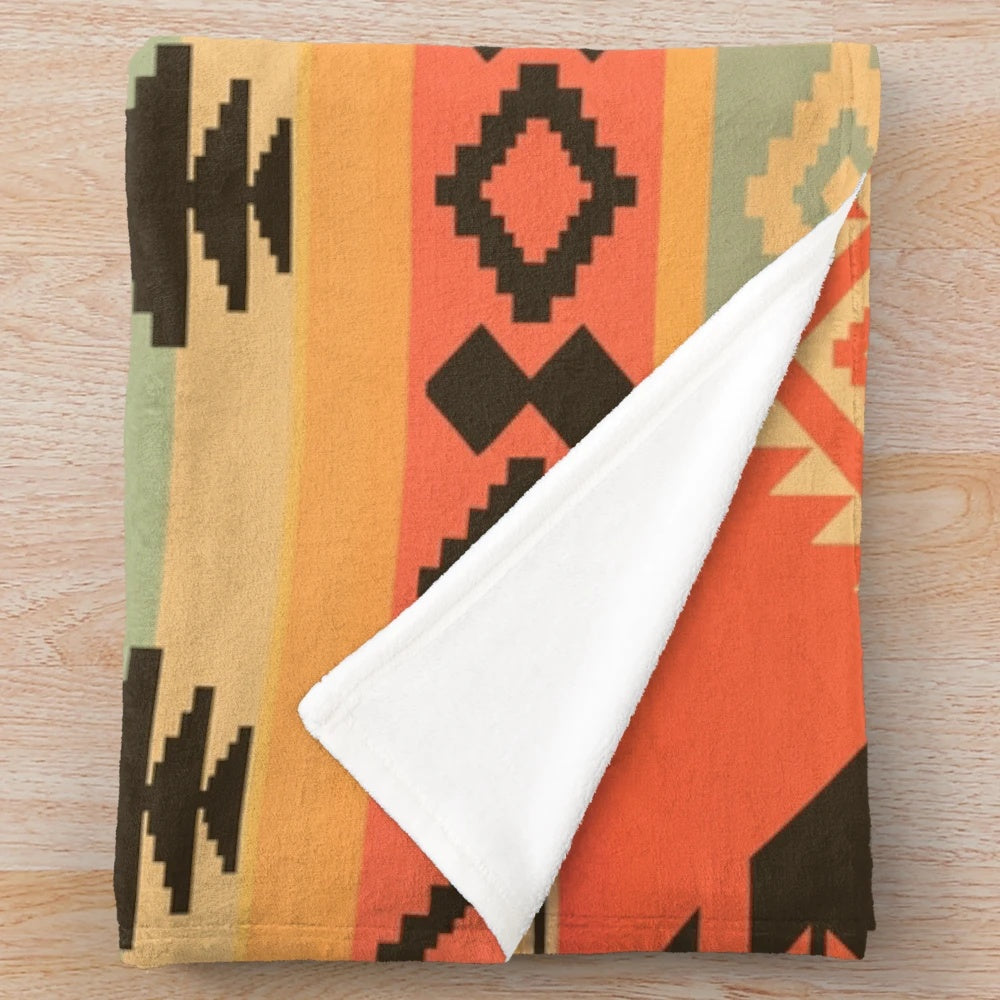 A plush and cozy blanket featuring a beautiful native american-inspired tribal pattern design.