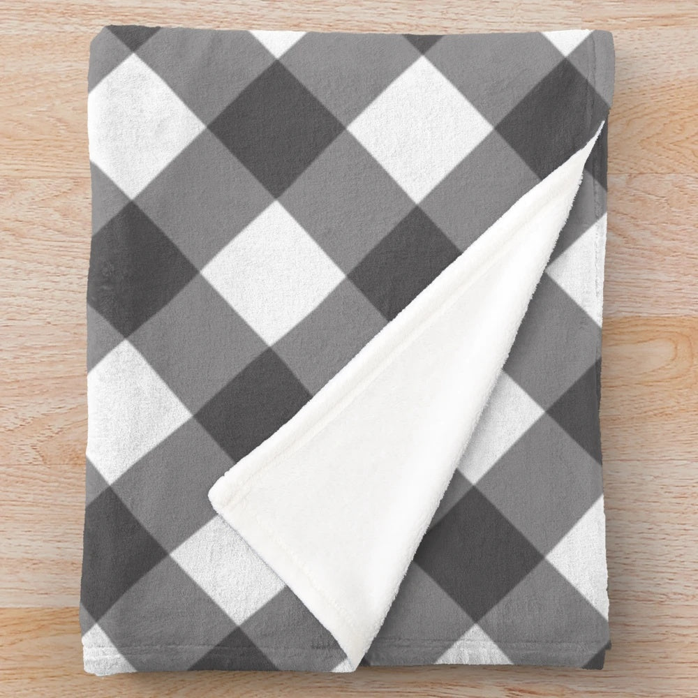 Diagonal plaid pattern plush blanket in black and white