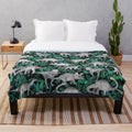 Dinosaur Jungle Plush Blanket with green leaves and dinosaurs