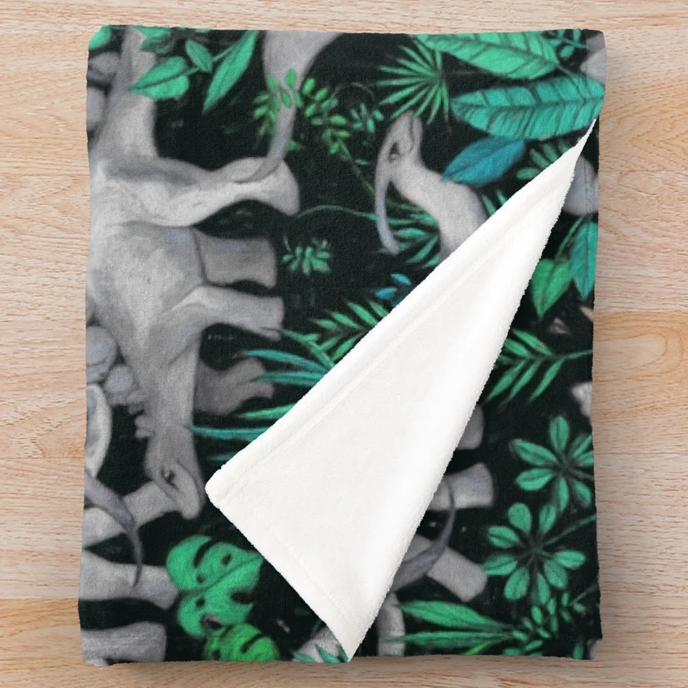 Dinosaur Jungle Plush Blanket with green leaves and dinosaurs