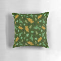 A green pillow with a whimsical dinosaur pattern, featuring brontosaurus and triceratops.