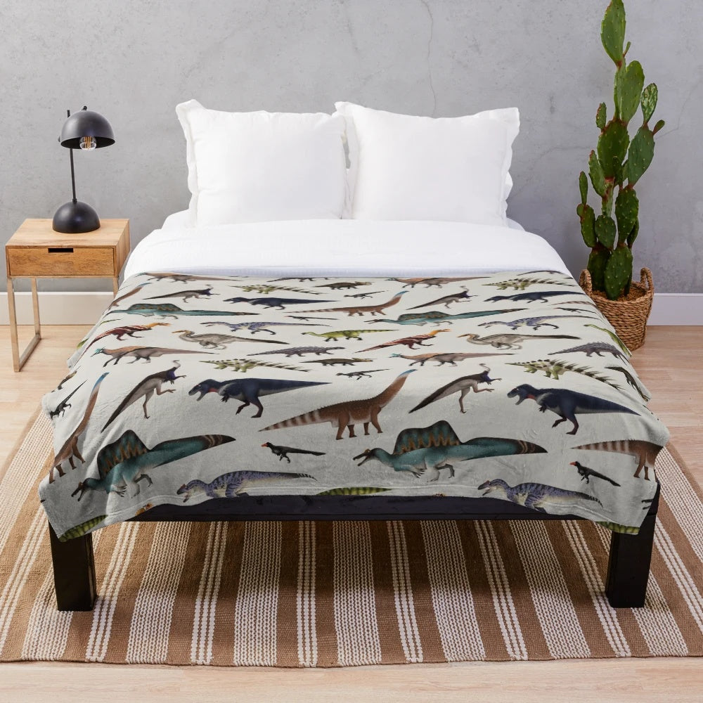 Dinosaur plush blanket with various prehistoric creatures