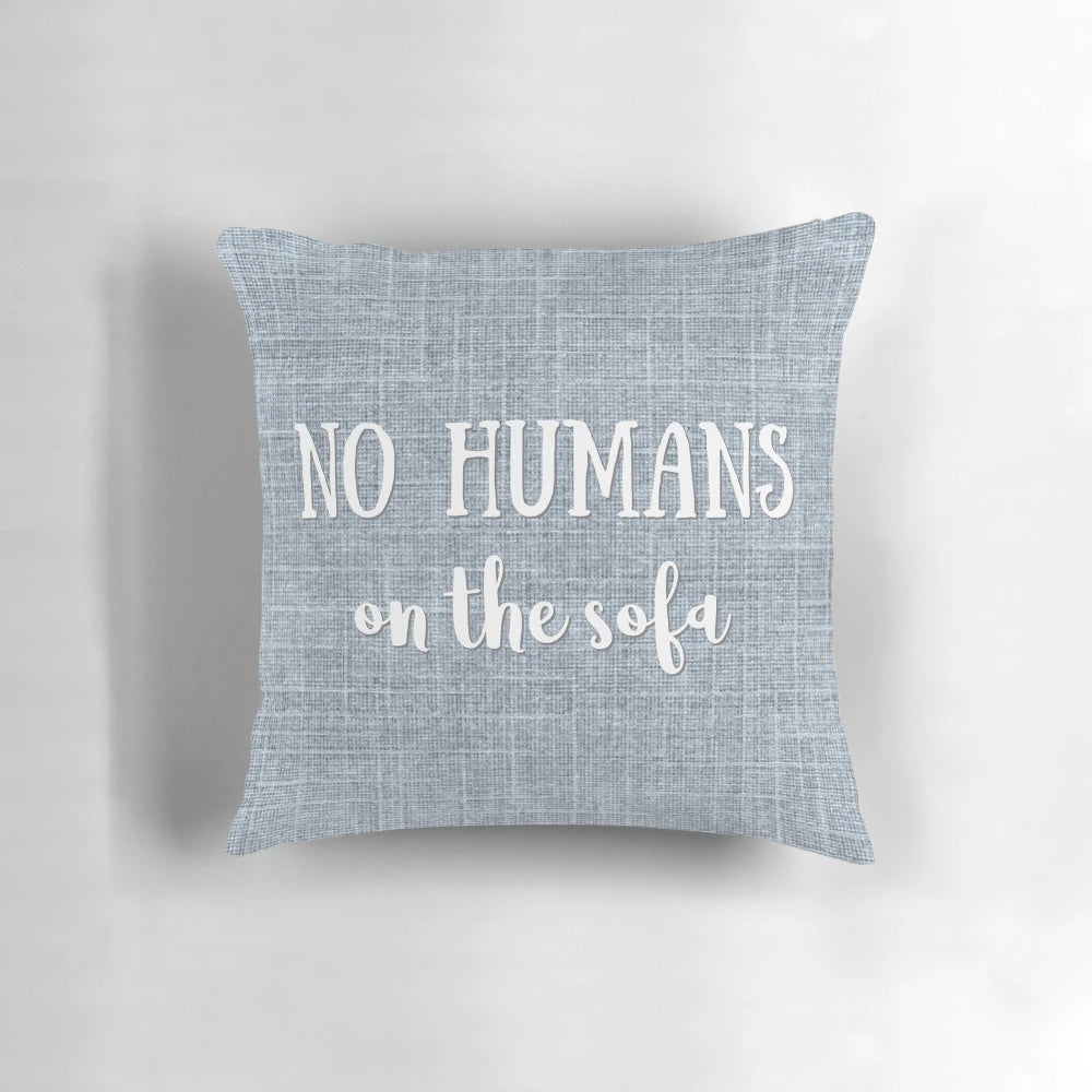 A gray and white decorative pillow with a playful "No Humans on the Sofa" dog-themed design.