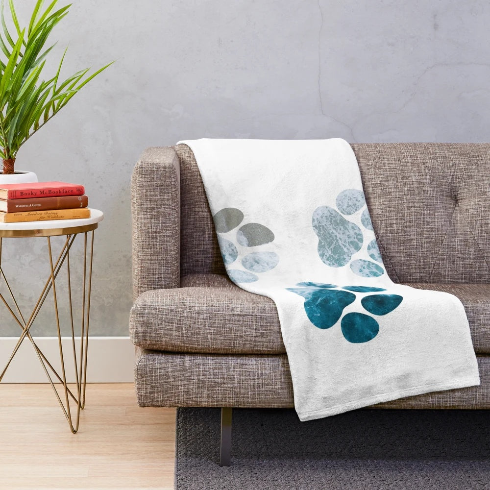 Dog paw prints design on a plush, cozy blanket with beach waves and sand motif
