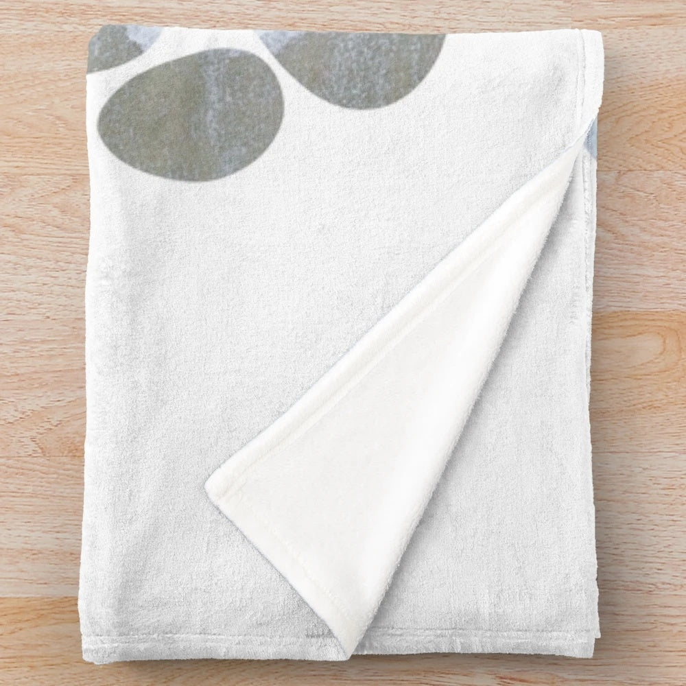 Dog paw prints design on a plush, cozy blanket with beach waves and sand motif
