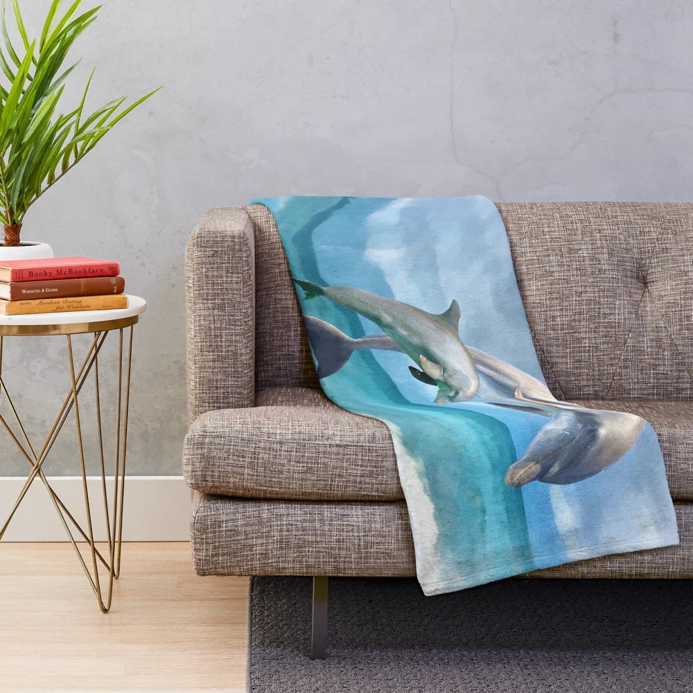 Colorful plush blanket featuring playful dolphins swimming in the ocean