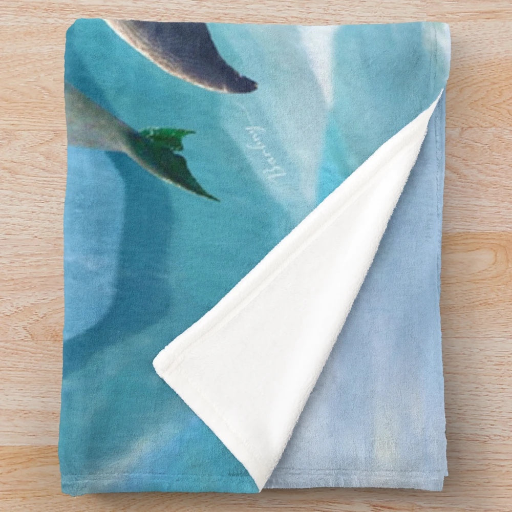 Colorful plush blanket featuring playful dolphins swimming in the ocean