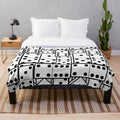 Dominoes-themed plush blanket in black and white colors