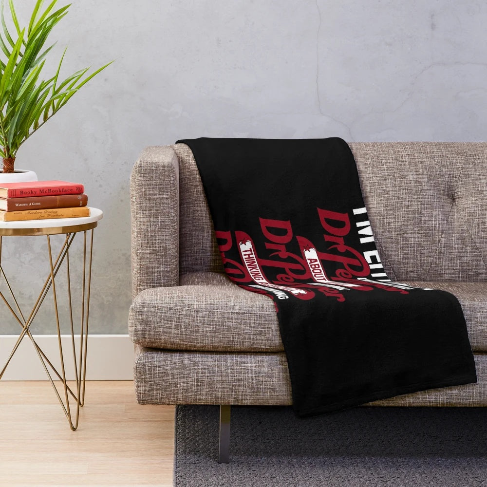 Soft and plush blanket with a humorous "I'm Either Drinking Dr. Pepper About to Drink Dr. Pepper" design, perfect for soda enthusiasts.