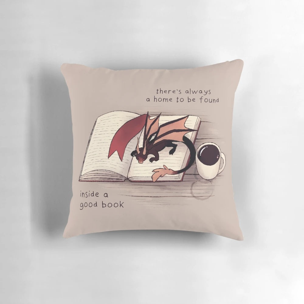 A soft, plush dragon-shaped pillow with a book-inspired design, perfect for creating a cozy, magical atmosphere.