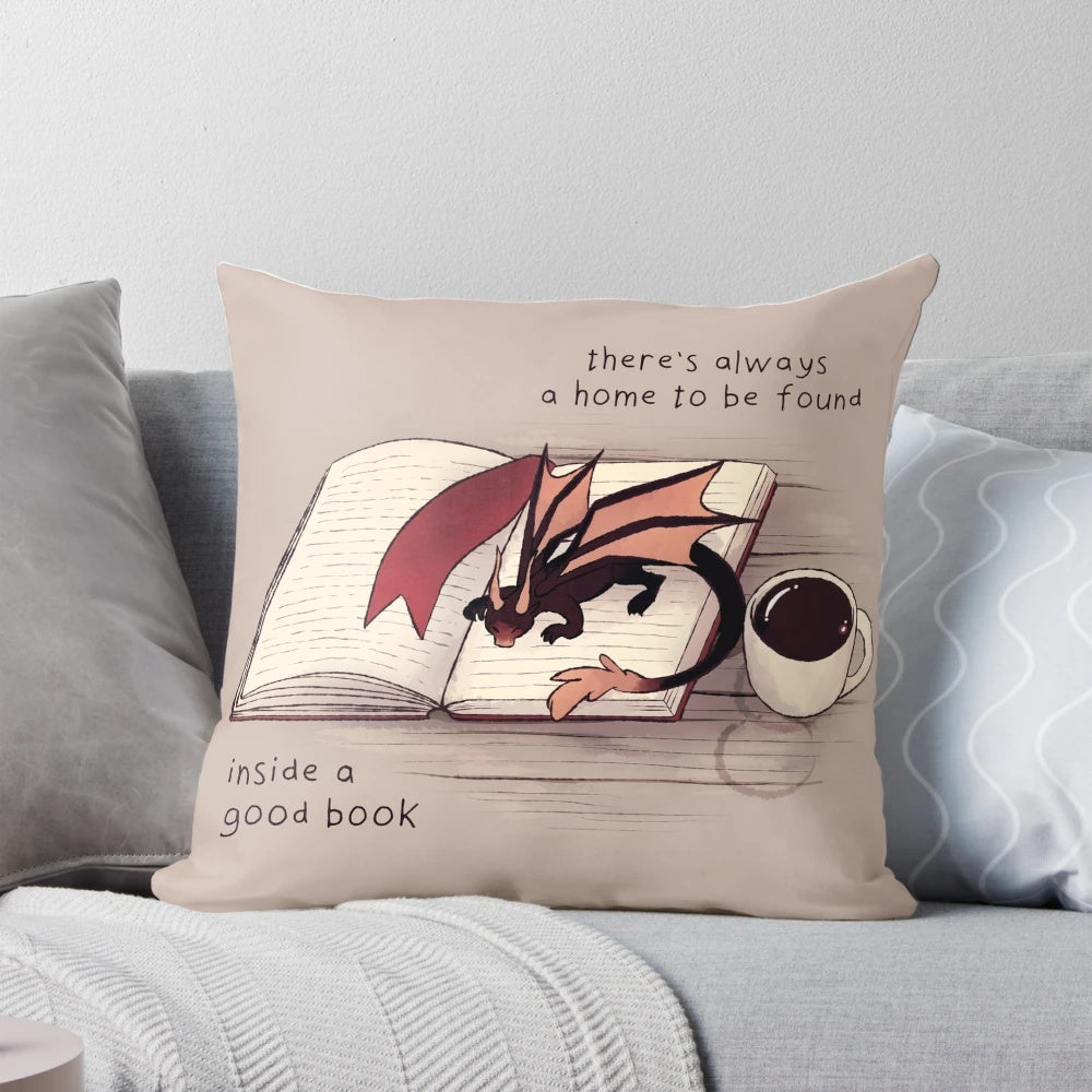 A soft, plush dragon-shaped pillow with a book-inspired design, perfect for creating a cozy, magical atmosphere.