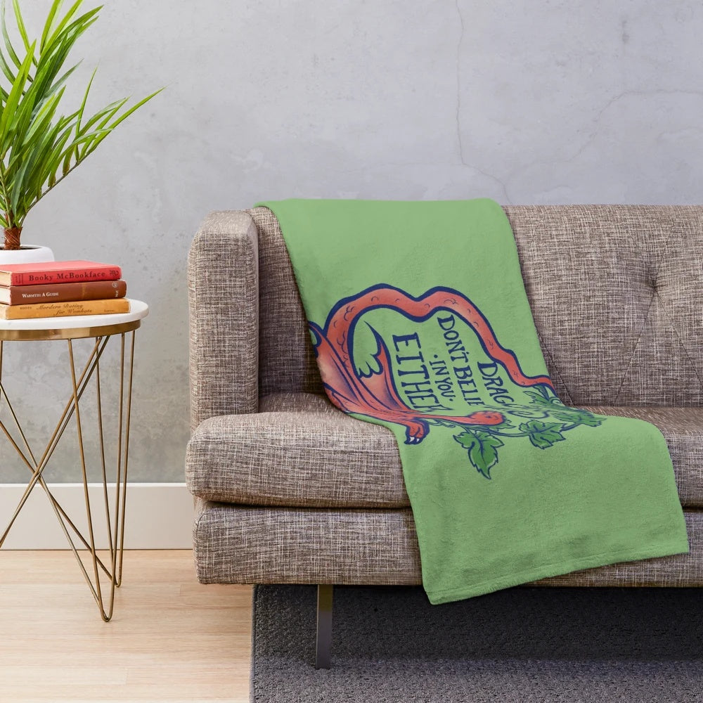 Plush dragon-themed blanket with "Dragons don't believe in you either" design