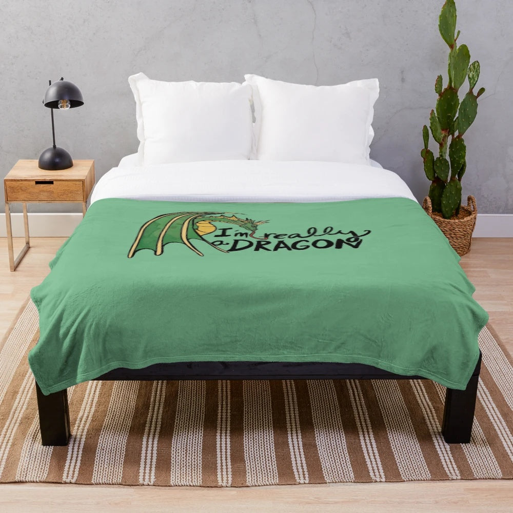 Plush dragon-themed blanket with green and blue accents