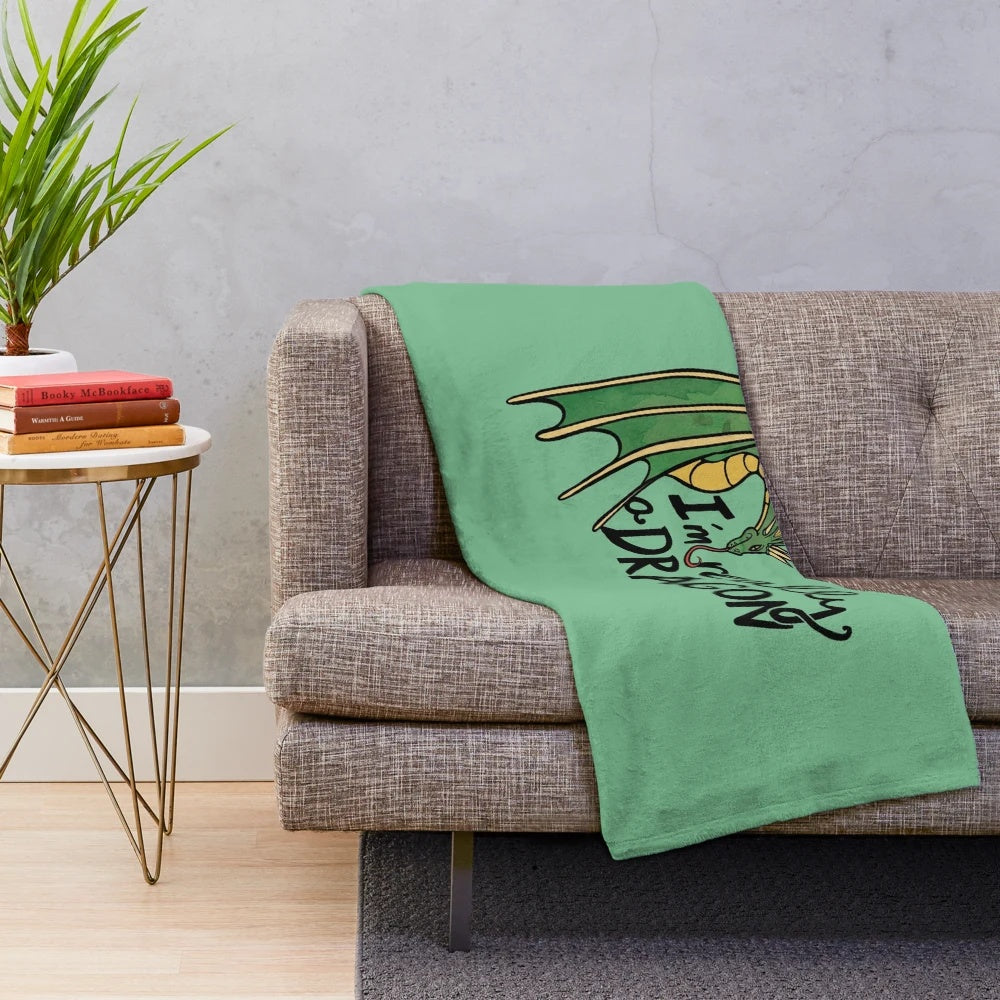 Plush dragon-themed blanket with green and blue accents