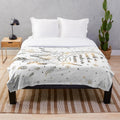 Cozy plush blanket featuring a dreamcatcher design with stars and feathers