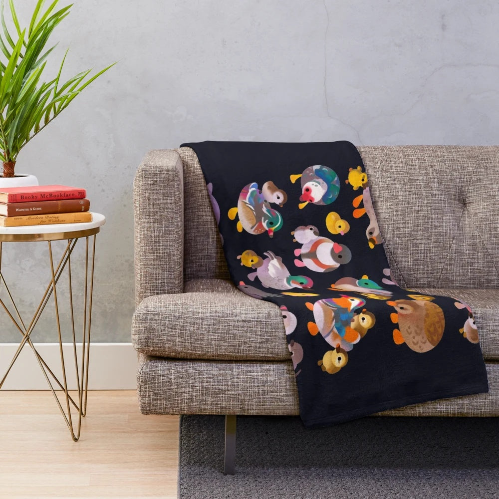A plush blanket featuring a duck and duckling design, perfect for cozy, rustic home decor.