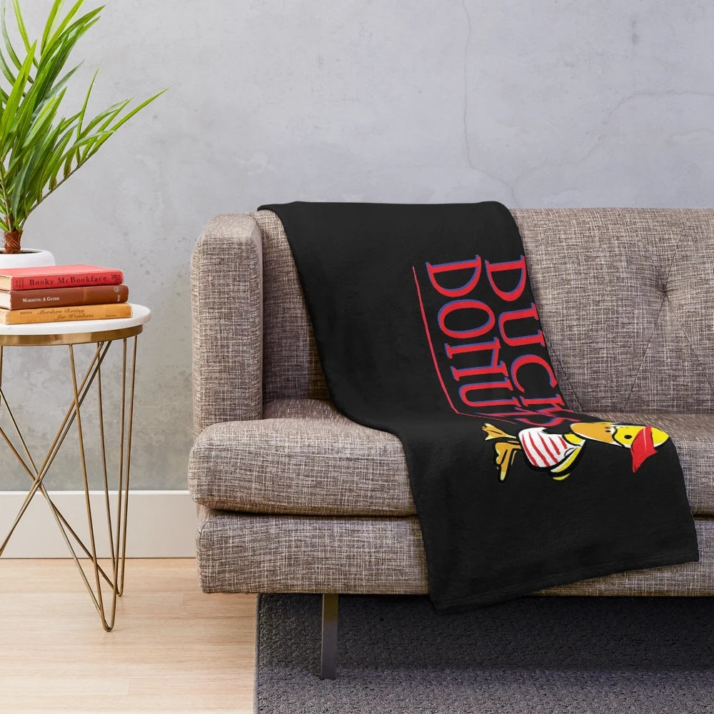 Plush blanket featuring a duck and doughnuts design