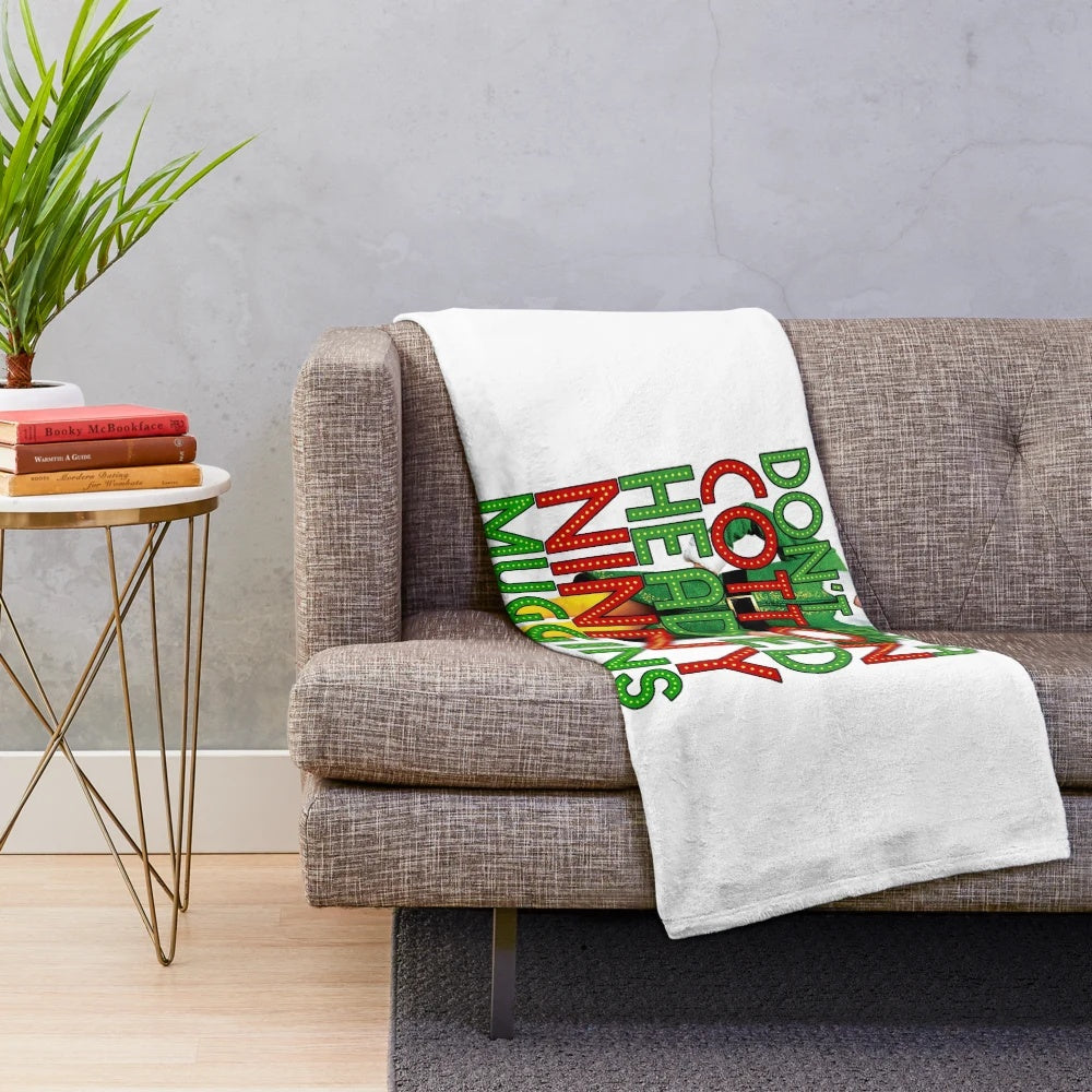 Elf-inspired plush blanket featuring the "Cotton Headed Ninny Muggins" quote from the Christmas movie
