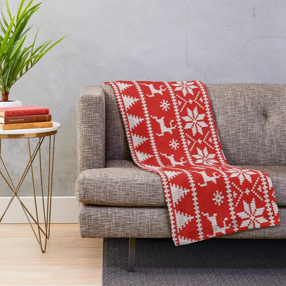 Fair Isle style Christmas plush blanket with geometric patterns, snowflakes, and reindeer