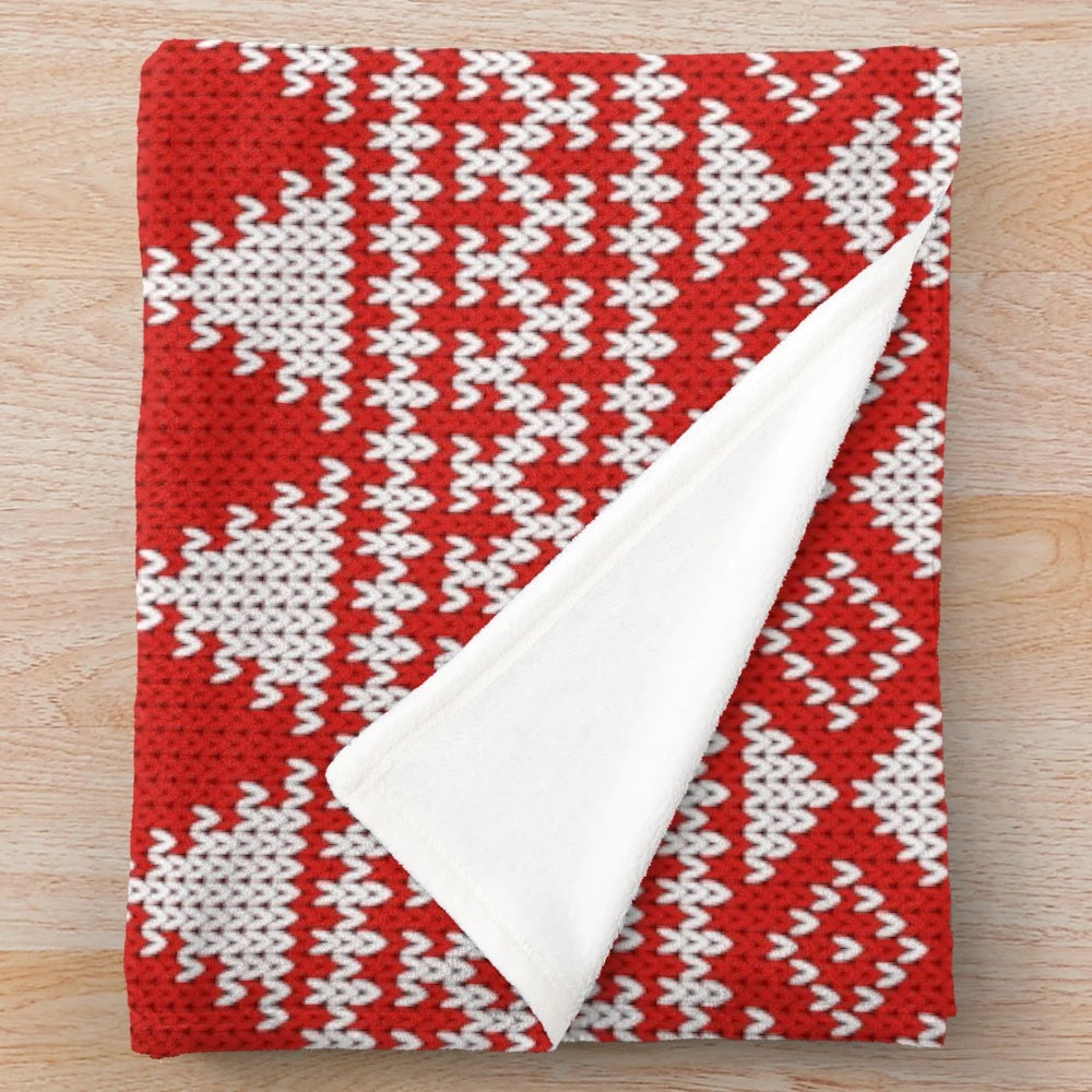 Fair Isle style Christmas plush blanket with geometric patterns, snowflakes, and reindeer