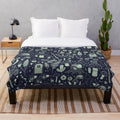 Plush blanket featuring a fairy garden design with mushrooms, butterflies, and flowers in a midnight theme