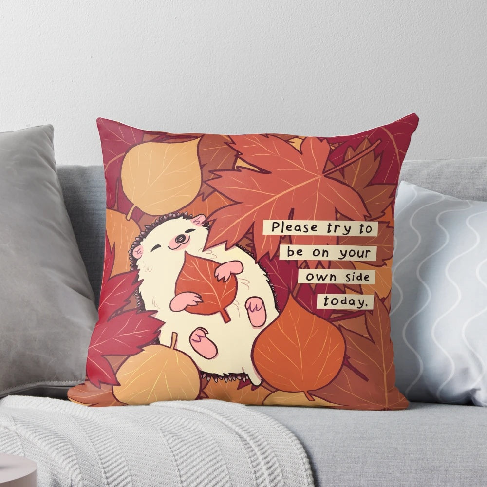 A soft, plush pillow featuring a charming hedgehog surrounded by colorful fall leaves