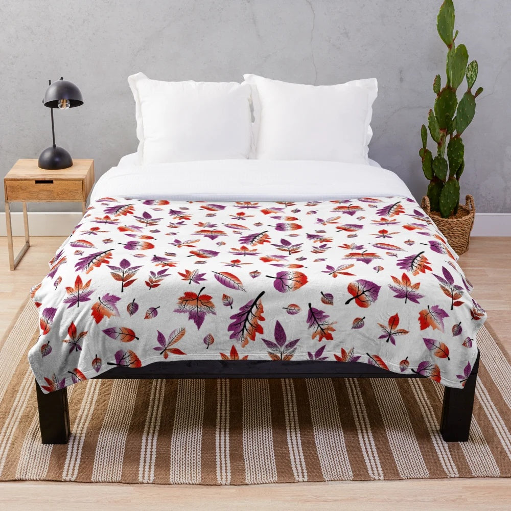 Plush blanket featuring fall leaves in pastel purple, pink, and orange colors representing the lesbian pride flag
